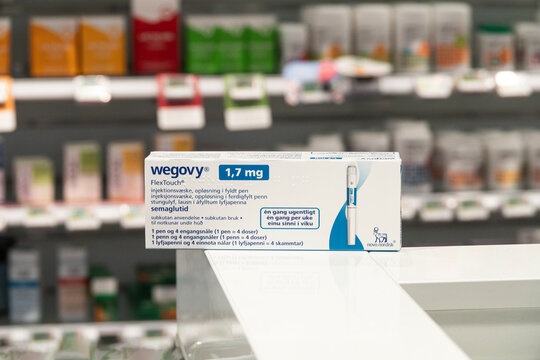 Packaging box of Wegovy (semaglutide) injectable prescription medication, weight-loss drug from Novo Nordisk AS. Pharmacy shop shelves in background. Copenhagen, Denmark - November 13, 2023.
