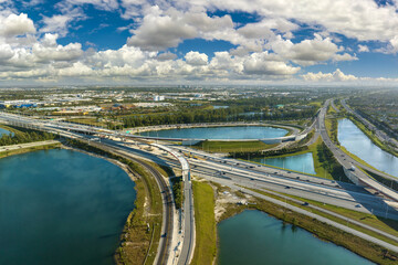 View from above of USA transportation infrastructure. Aerial view of american highway junction with fast driving vehicles in Miami, Florida