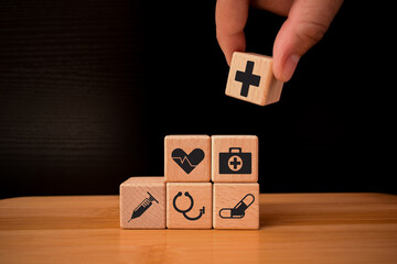Wooden Cube Blocks icon, Healthcare and Insurance,medical concept, Wooden cubes stack in pyramid shaped with healtcare and medical insurance icon over  with copyspace use for Health Insurance idea.
