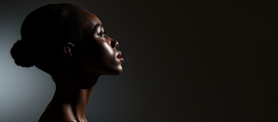  a close up of a woman's face with her eyes closed and her hair pulled back in a bun. - obrazy, fototapety, plakaty