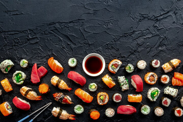 Sushi with chopsticks and soy sauce, with copy space. An assortment of rolls, maki, nigiri etc,...