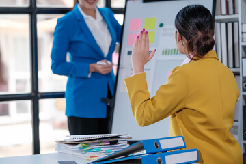 Shot of a group of businesspeople sitting together in a meeting.