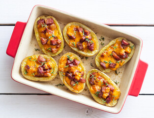 Baked potatoes with bacon, cheese and thyme. Homemade food.