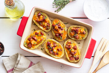 Baked potatoes with bacon, cheese and thyme. Homemade food.