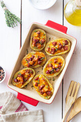 Baked potatoes with bacon, cheese and thyme. Homemade food.