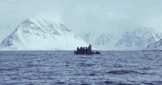 Researchers on a Rib Zodiac research boat in the Arctic Circle, Svalbard