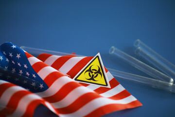 American flag and biohazard sign. The concept of American biolabs and research centers.