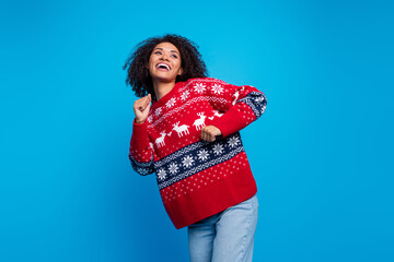 Photo of crazy cheerful girl wear trendy ugly sweater looking empty space dancing winter event isolated on blue color background