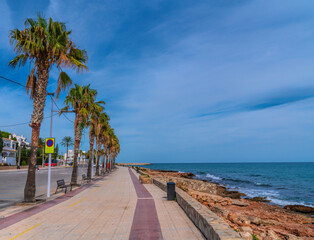 Alcossebre Spain promenade with palm trees between town and Platja de les Fonts beach