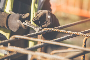 Construction worker steel fixer working at the building  site close-up