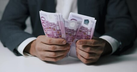 closeup of businessman hands counting 500 euro money banknotes - Powered by Adobe