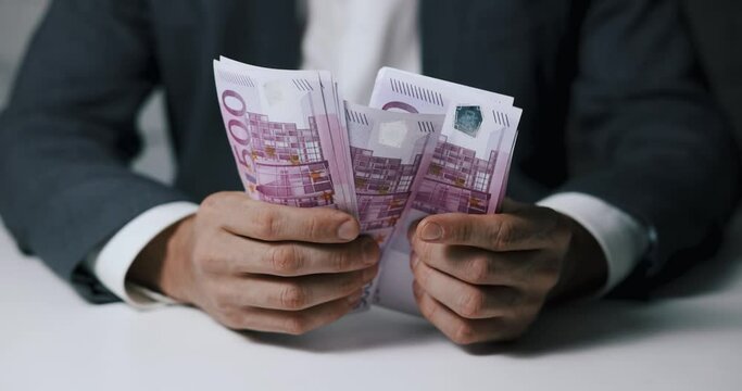 closeup of businessman hands counting 500 euro money banknotes