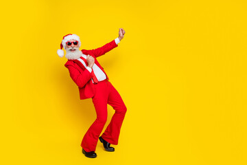 Fototapeta na wymiar Full length photo of excited cheerful claus wear red tux costume dancing disco having fun empty space isolated yellow color background