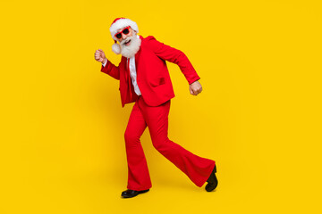 Fototapeta na wymiar Full length photo of positive handsome claus wear red tux costume dancing having fun disco isolated yellow color background