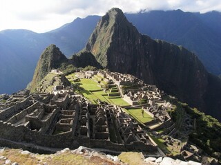 Ancient Machu Picchu city in Peru with big mountains in the background on a sunny day