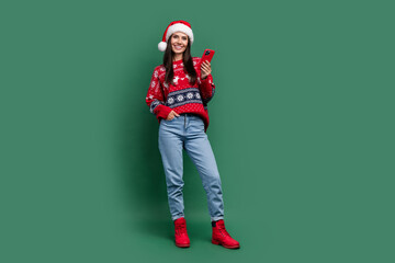 Full length photo of sweet shiny lady santa helper dressed print xmas sweater chatting instagram...