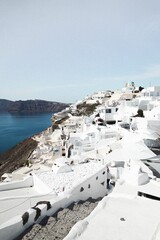 Vertical shot of traditional white buildings in Santorini, Greece