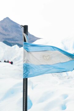 Vertical shot of the Argentina flag with a background of snow