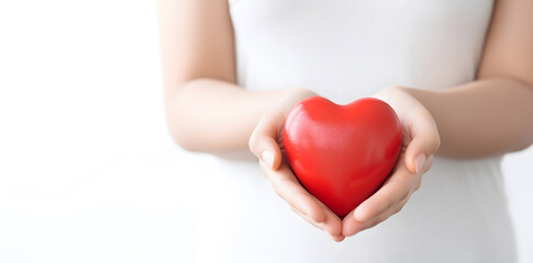 Female hand holding red heart isolated on white background 