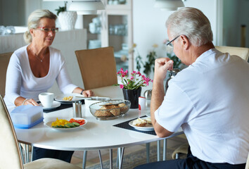 Senior, couple and eating breakfast in morning with healthy food, nutrition or diet in retirement. Happy, old people and together at brunch in dining room with vegetables and fruit for health