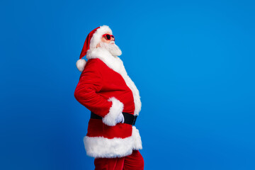 Photo portrait of retired old man touch belt shopping promo wear trendy santa claus costume coat isolated on blue color background