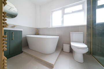Naklejka na ściany i meble Bright, modern bathroom with white bathroom suite and green cabinet.
