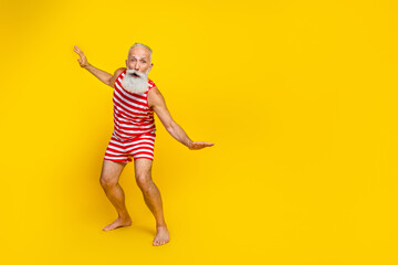 Fototapeta na wymiar Full body length size photo of carefree active sportsman elderly pensioner having fun when surfing isolated on yellow color background