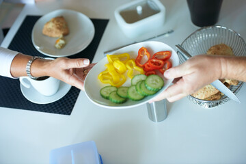 People, hands and passing salad at breakfast table for vegetables, diet or healthy eating at home. Closeup of person giving plate of natural organic food for nutrition snack or meal together at house - Powered by Adobe