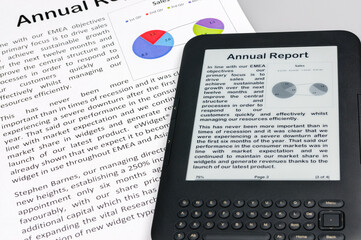 E-reader showing a company annual report with a printed copy