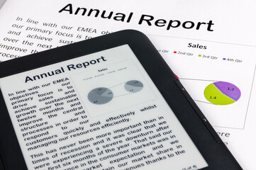 E-reader showing a company annual report with a printed copy