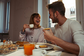 Fototapeta na wymiar Happy couple making breakfast at home. Concept about lifestyle, healthy food and relationship