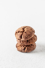 Stack of chocolate brownie cookies with crack on white background isolated. Homemade crinkle cookies
