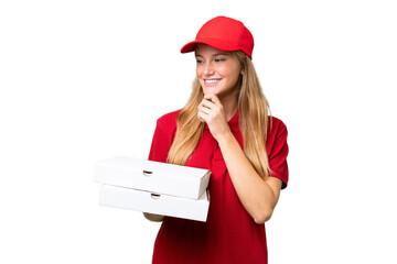 Young caucasian pizza delivery woman with work uniform picking up pizza boxes over isolated...