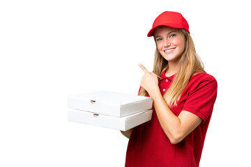 Young caucasian pizza delivery woman with work uniform picking up pizza boxes over isolated...