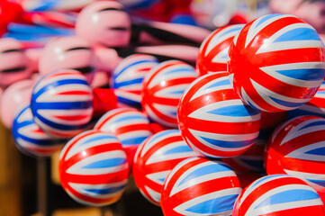 Red, white and blue union jack band sticks on sale on a stall during a Twelfth of July parade