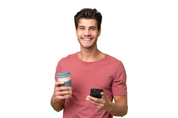 Young handsome caucasian man over isolated background holding coffee to take away and a mobile