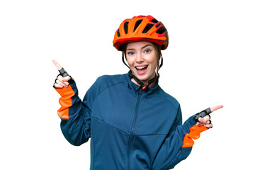 Young cyclist woman over isolated chroma key background pointing finger to the laterals and happy - obrazy, fototapety, plakaty