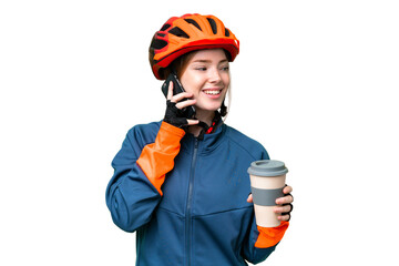 Young cyclist woman over isolated chroma key background holding coffee to take away and a mobile - obrazy, fototapety, plakaty