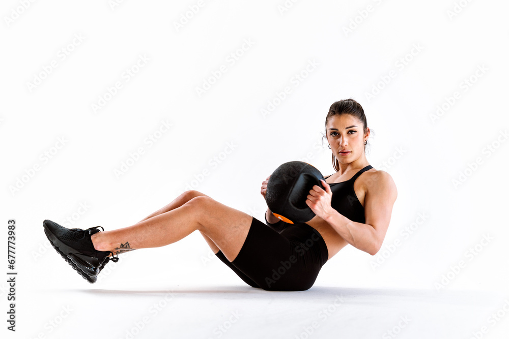 Poster Young female athlete training in a gym using sport equipment. Fit woman working out . Concept about fitness, wellness and sport preparation.