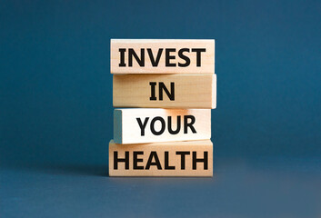 Invest in your health symbol. Concept word Invest in your health on beautiful wooden block. Beautiful grey table grey background. Invest in your health concept. Copy space.