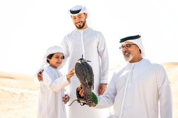 Three generation family making a safari in the desert of Dubai. Grandfather, son and grandson...