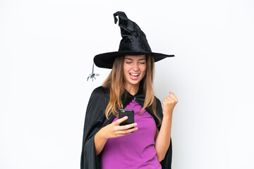 Young caucasian woman costume as witch isolated on white background with phone in victory position