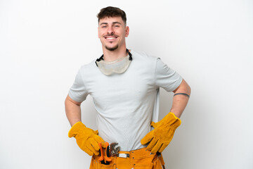 Young caucasian electrician man isolated on white background posing with arms at hip and smiling