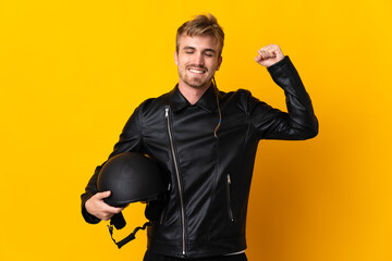 Man with a motorcycle helmet isolated on yellow background doing strong gesture