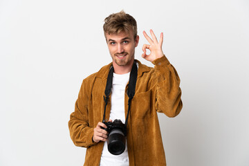 Young photographer blonde man isolated on white background showing ok sign with fingers