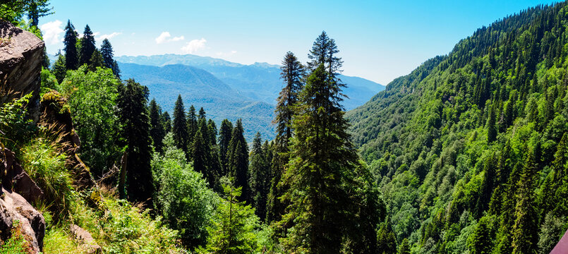 Panorama: view of the Caucasus Mountains in summer from the observation deck in the Mendelikha Waterfalls Park at the Rosa Khutor resort in the Adler district of Sochi