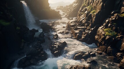 A high-angle shot of a waterfall winding through a rocky landscape, highlighting the contrast between the soft flow of water and the hard stone.