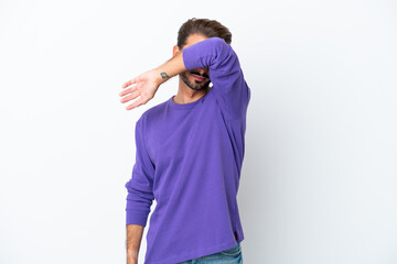Young caucasian man isolated on white background covering eyes by hands