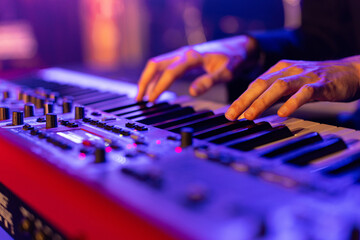 Close up of a keyboardist musician at work during concert