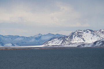 Fototapeta na wymiar Snow-covered winter pastel colors landscape. View of the blue da